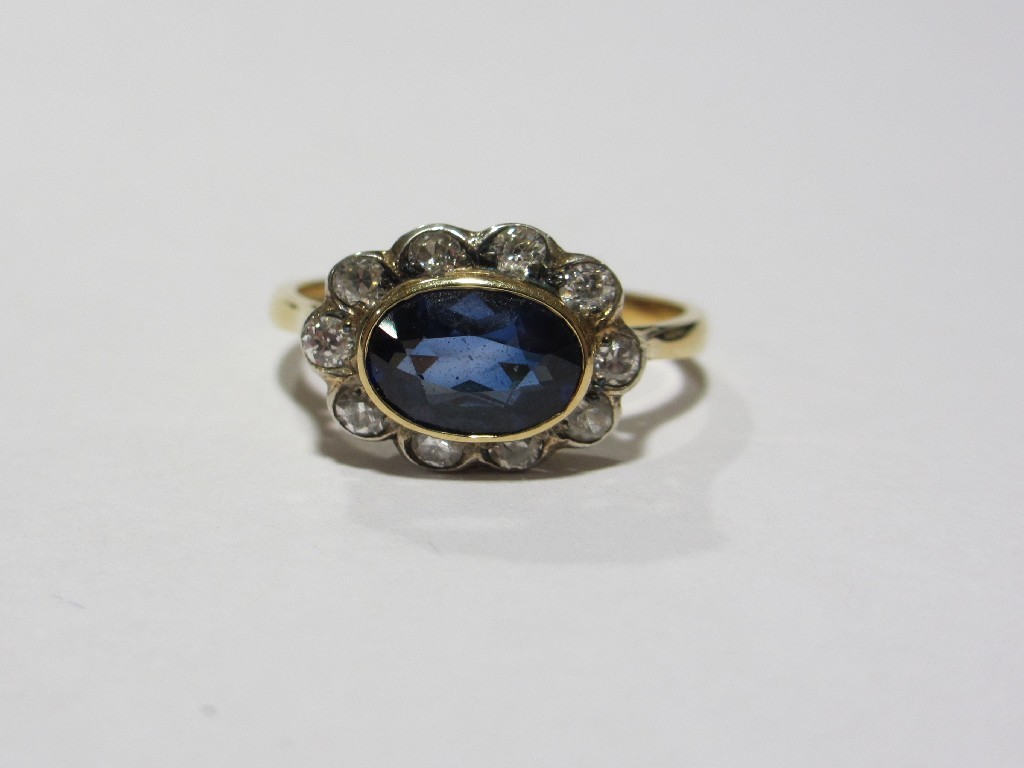 Appraisal: Eighteen carat gold sapphire and diamond cluster ring with oval