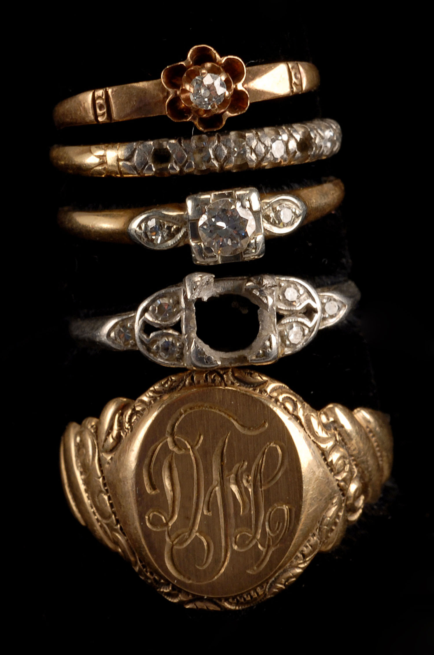 Appraisal: FIVE GOLD RINGS Three unmarked one kt white gold and