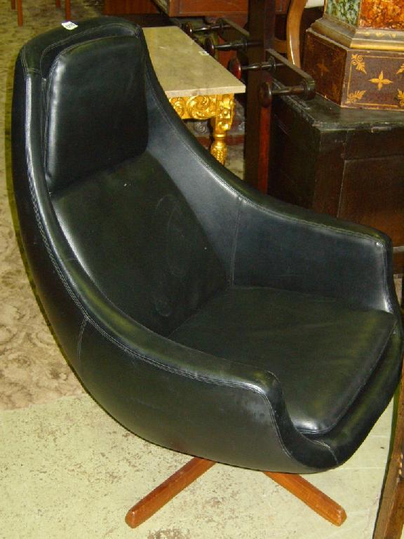 Appraisal: A 's easy chair with black leather upholstery and quadruped