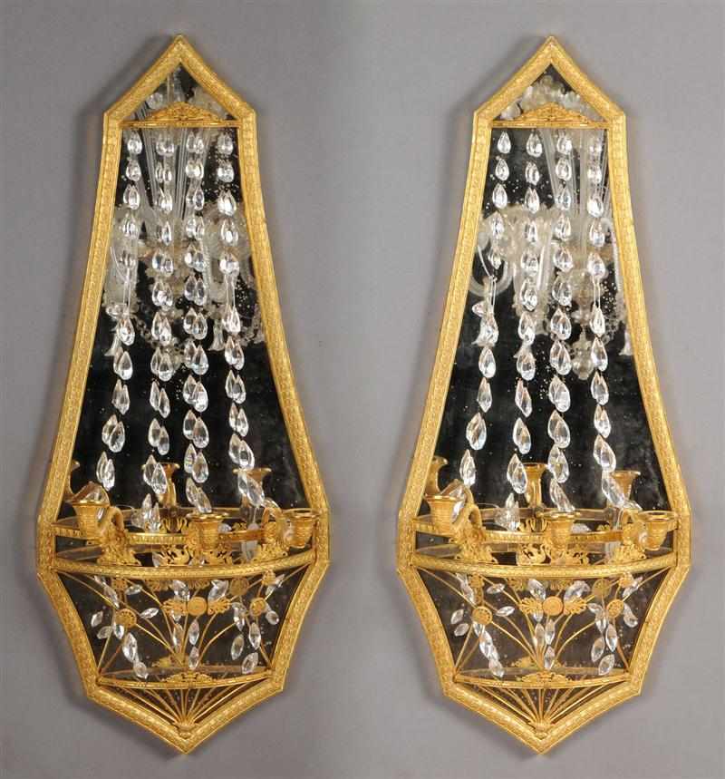 Appraisal: PAIR OF EMPIRE STYLE CUT-GLASS MOUNTED GILT-BRONZE MIRROR-BACKED THREE-LIGHT WALL