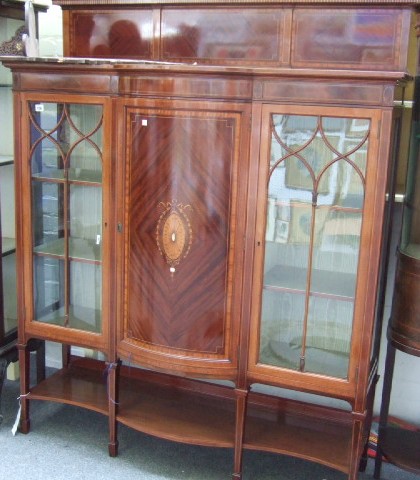 Appraisal: An Edwardian inlaid mahogany bowfront display cupboard the central inlaid