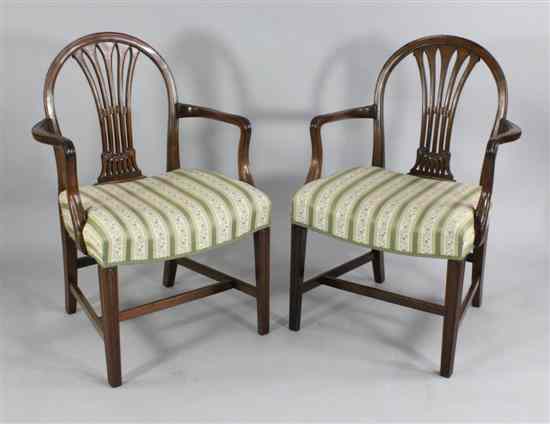 Appraisal: A pair of Hepplewhite style carved mahogany elbow chairs with