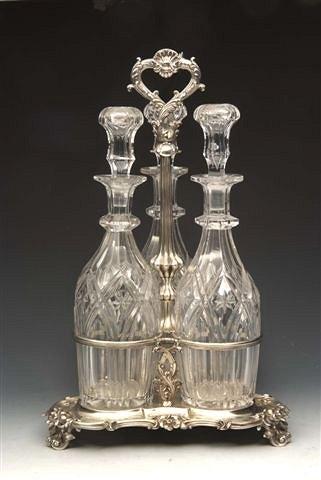 Appraisal: A VICTORIAN SILVER DECANTER STAND on triangular base with scroll