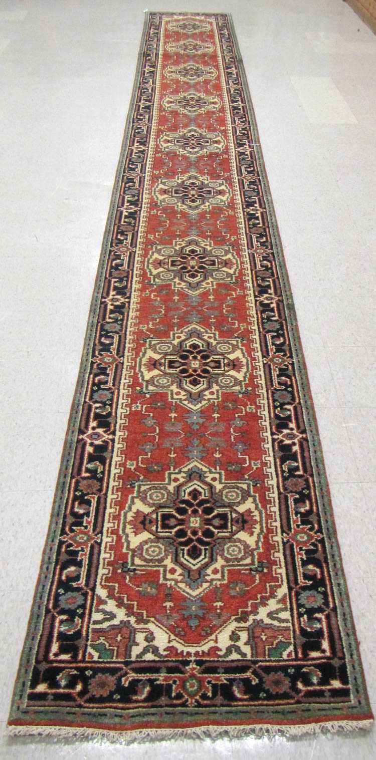 Appraisal: HAND KNOTTED ORIENTAL LONG RUG Persian Serapi design geometric medallions