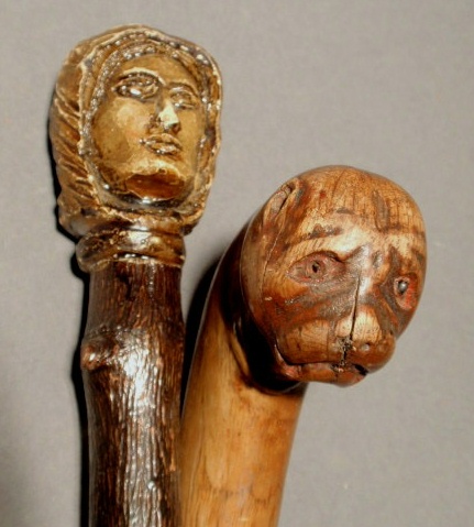 Appraisal: Carved dog head cane l and a carved human head