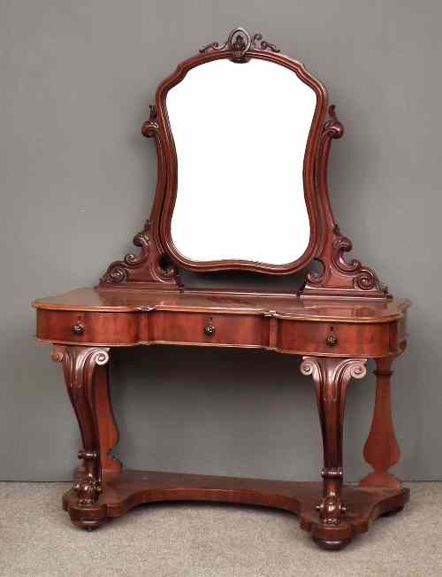 Appraisal: A Victorian mahogany ''Duchess'' dressing table with shaped mirror on