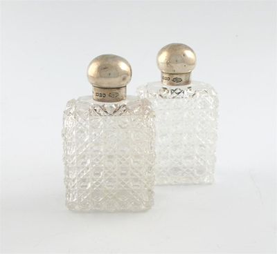 Appraisal: A pair of late-Victorian silver mounted cut glass scent bottles