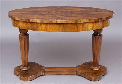 Appraisal: BIEDERMEIER WALNUT CENTER TABLE The oval figure-veneered top above a