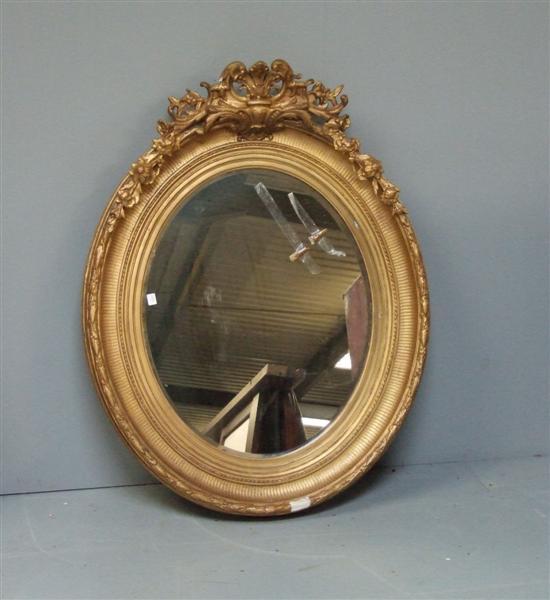 Appraisal: Large oval giltwood and gesso framed mirror th century with