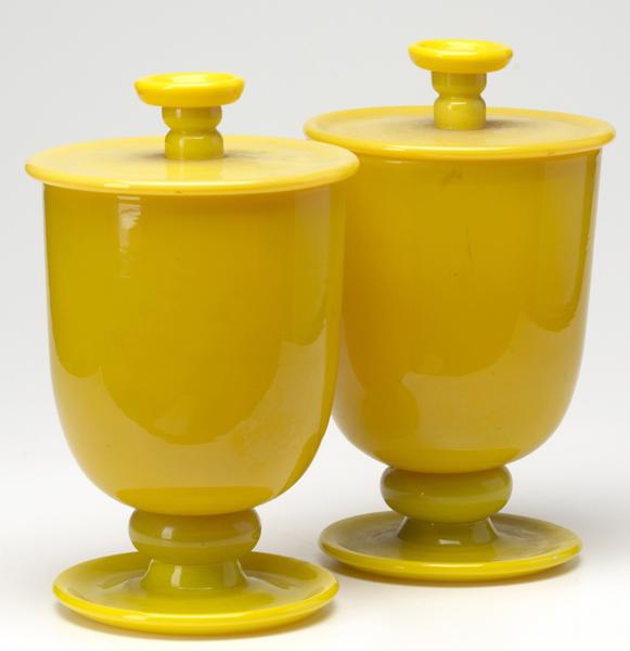 Appraisal: GLASS URNS Pair of Sunflower Yellow glass covered urns ca