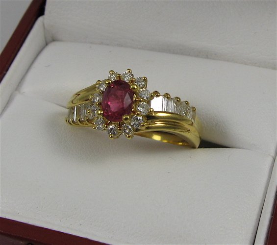 Appraisal: RUBY DIAMOND AND K GOLD RING centering an oval-cut red