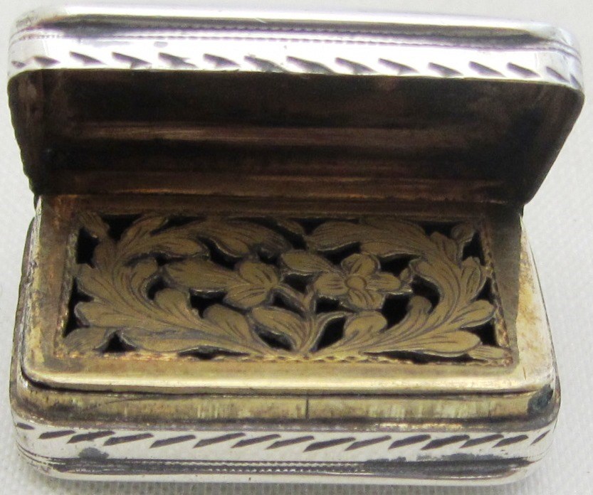 Appraisal: A silver rectangular hinge lidded vinaigrette with engraved decoration by