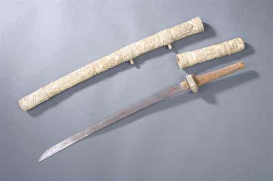 Appraisal: JAPANESE IVORY KATANA Meiji period The handle and scabbard carved