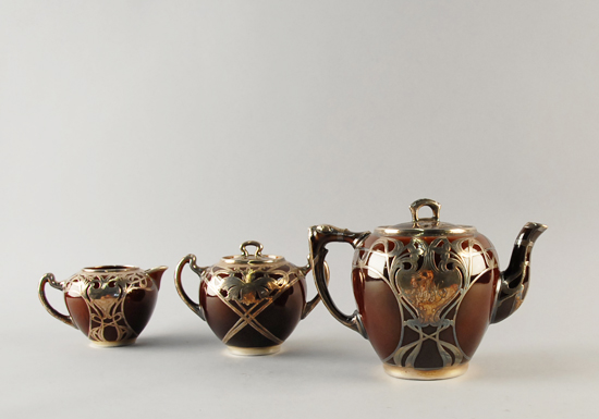 Appraisal: An English Pottery and Sterling Overlay Tea Service the lidded