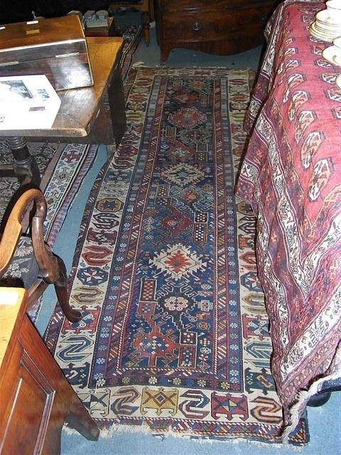 Appraisal: A PERSIAN BLUE GROUND RUNNER with central geometric motifs and