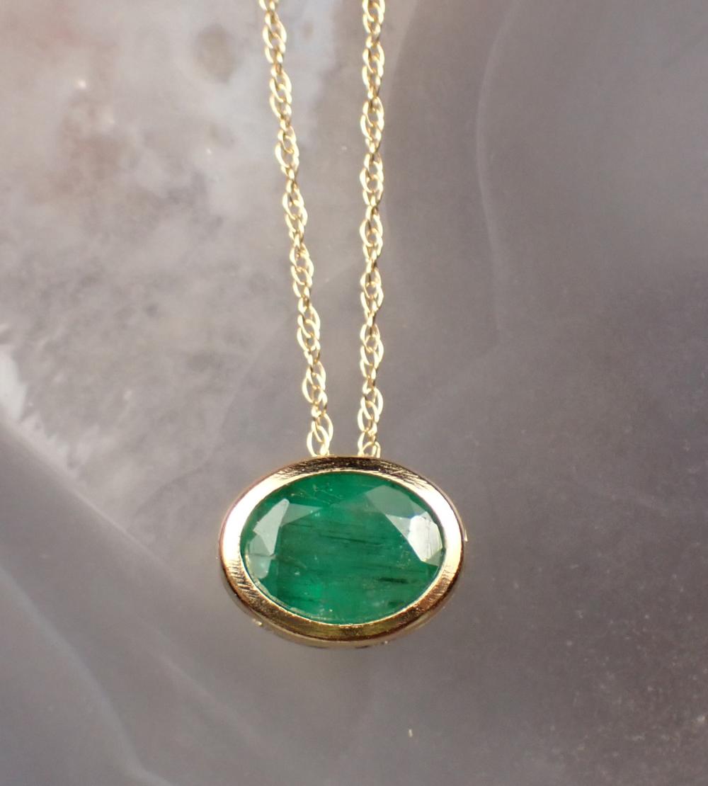 Appraisal: EMERALD AND FOURTEEN KARAT GOLD PENDANT NECKLACE with an dainty