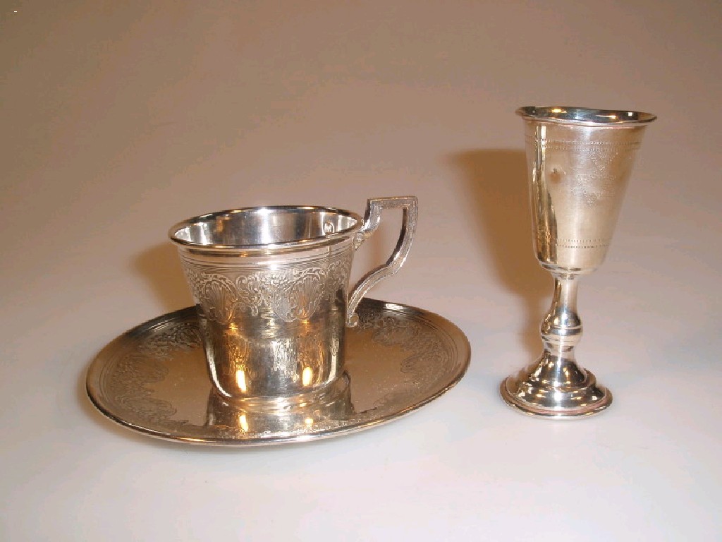 Appraisal: A continental silver cup and saucer with finely chased borders