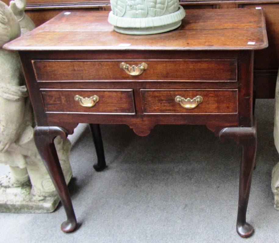 Appraisal: A George III oak lowboy the rectangular top with rounded