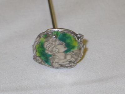 Appraisal: AN ART NOUVEAU SILVER ENAMEL HAT PIN depicting a lady's