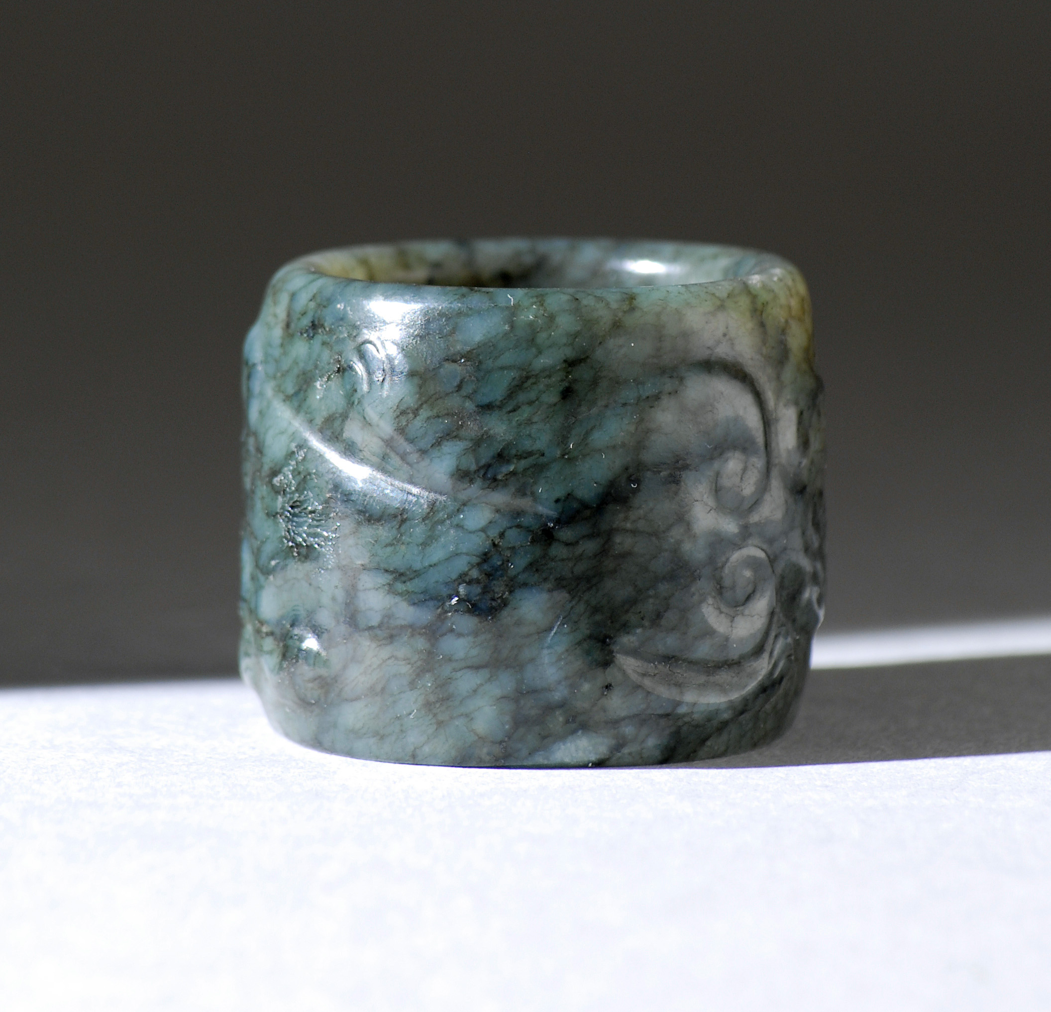 Appraisal: GRAY JADE SCHOLAR'S RING th CenturyWith relief qilin design From