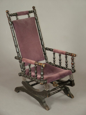 Appraisal: A ebonised rocking chair early th century with purple upholstered