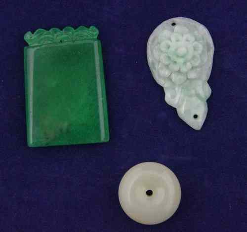 Appraisal: A jade button and two jade pendants