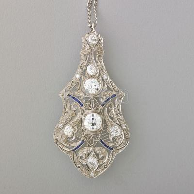 Appraisal: ART DECO DIAMOND PLATINUM FILIGREE PENDANT BROOCH Serpentine form with