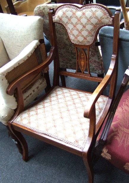 Appraisal: An Edwardian inlaid mahogany open armchair with shaped crest over