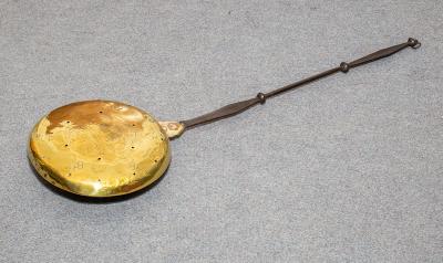 Appraisal: A Charles II brass warming pan with engraved decoration and