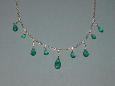 Appraisal: AN EMERALD AND DIAMOND NECKLACE comprising nine graduated emeralds of