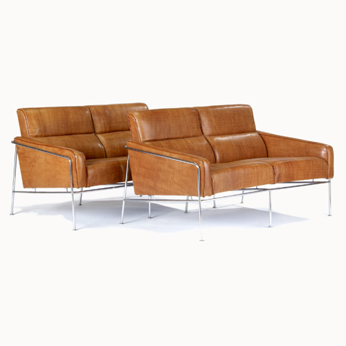 Appraisal: ARNE JACOBSEN Pair of brown leather settees on tubular chrome