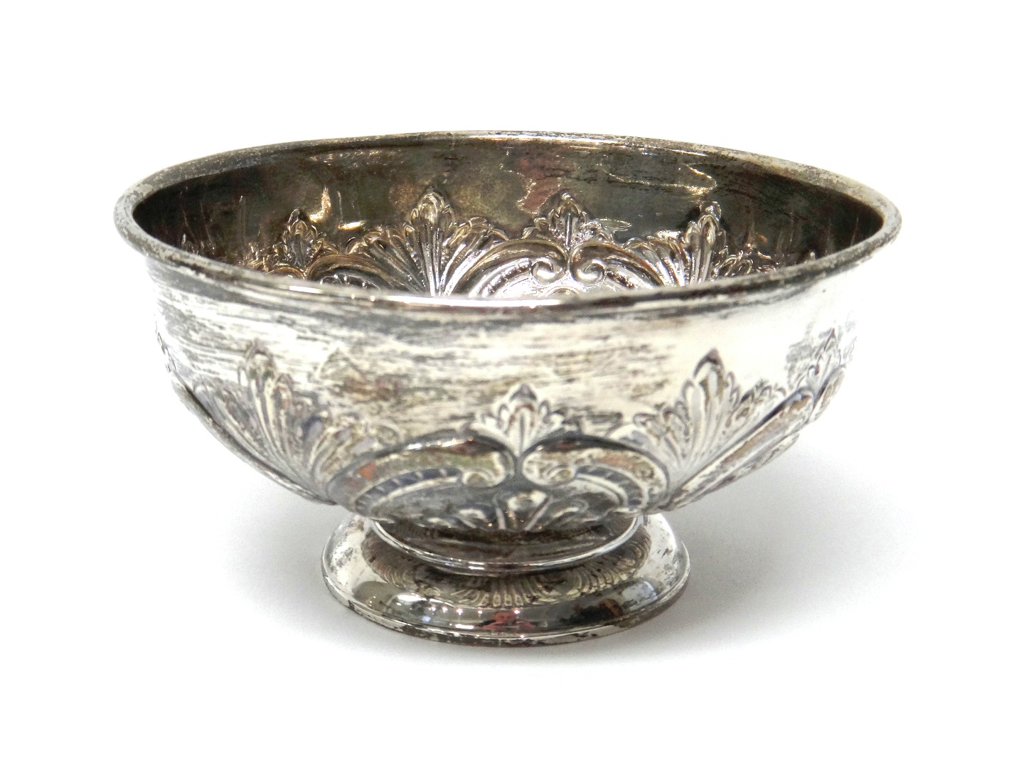 Appraisal: A silver circular bowl with scroll and fan embossed decoration