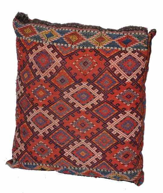 Appraisal: A PERSIAN LARGE RED GROUND CUSHION X together with a