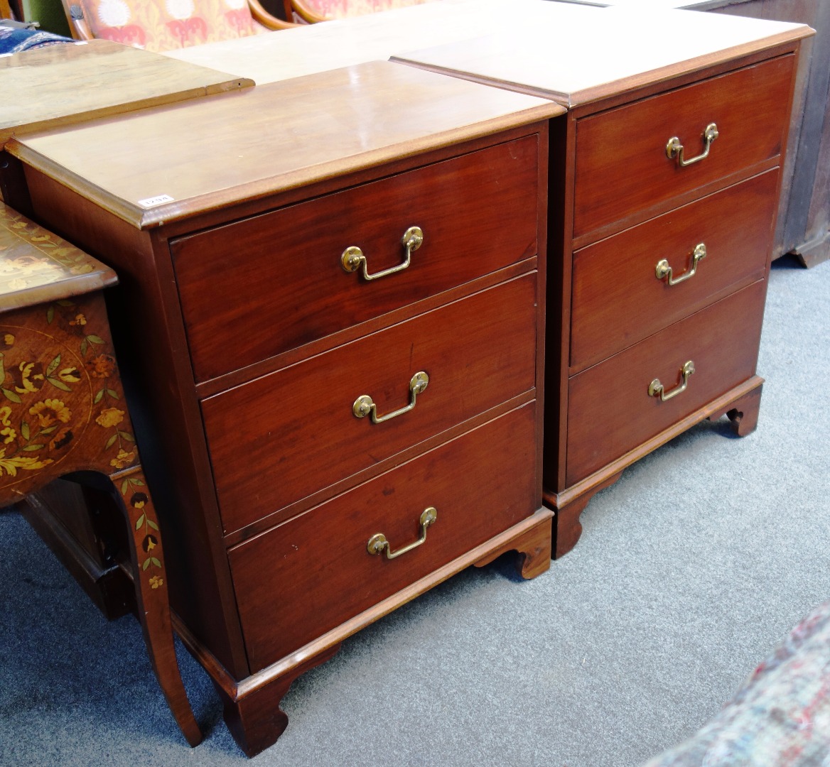 Appraisal: A pair of mahogany three drawer pedestal chests on bracket