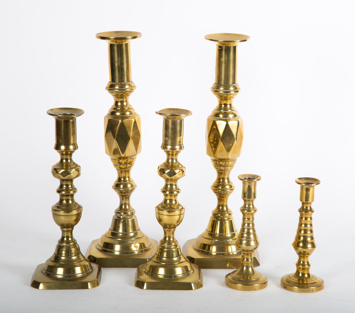 Appraisal: Three pairs of Victorian brass candlesticks to in H Condition