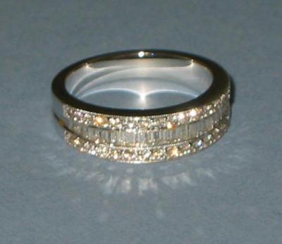 Appraisal: A DIAMOND HALF ETERNITY RING channel set with a row