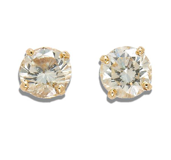 Appraisal: A pair of diamond solitaire earrings estimated total diamond weight