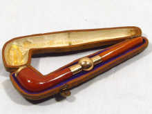 Appraisal: A gold mounted amber pipe in original fitted velvet lined