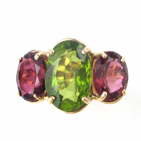 Appraisal: A peridot garnet and k gold three stone ring