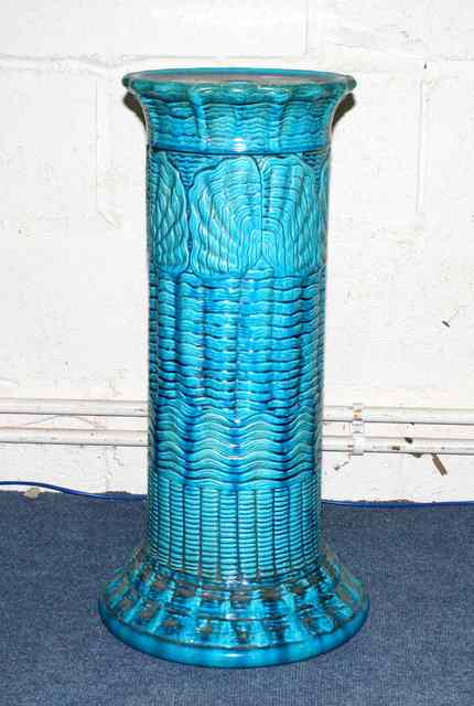 Appraisal: A BURMANTOFTS BLUE POTTERY JARDINIERE STAND with stylised butterfly decoration