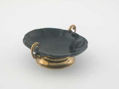 Appraisal: A continental silvergilt mounted small stone dish with two upswept