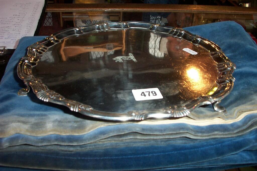 Appraisal: A silver salver with raised piecrust border and cabriole supports