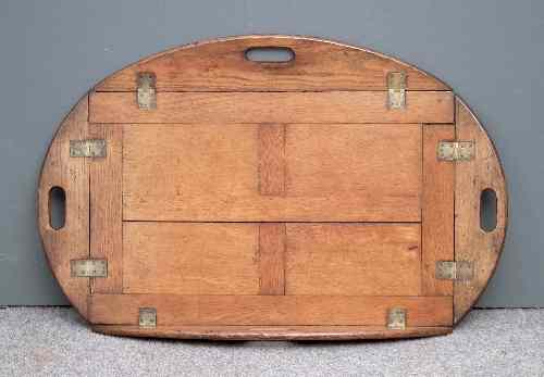 Appraisal: A Victorian butler's oak oval tray the folding sides with