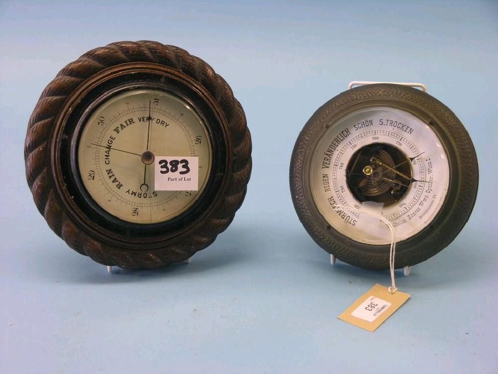 Appraisal: An oak aneroid barometer in rope-twist frame in and a