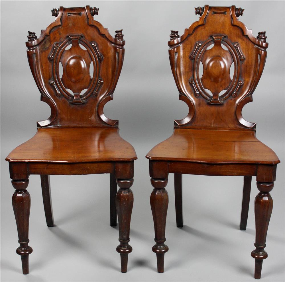 Appraisal: PAIR OF VICTORIAN CARVED MAHOGANY HALL CHAIRS both with carved