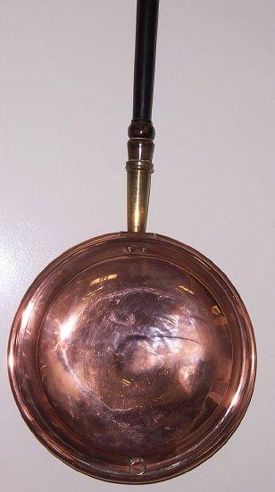 Appraisal: A Victorian copper warming pan with turned wood handle