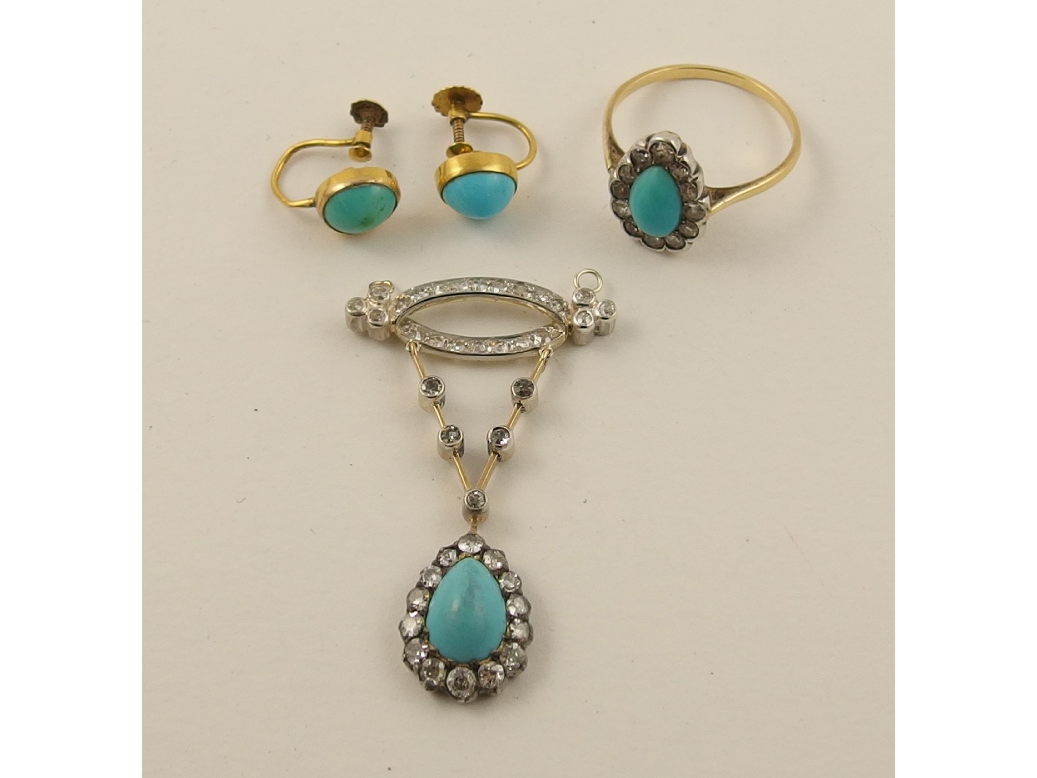 Appraisal: A turquoise and diamond pendanta pear shaped turquoise surrounded by