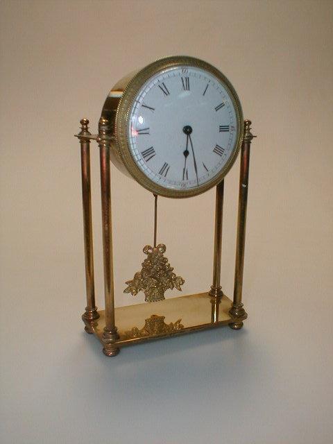 Appraisal: A gilt metal pediment clock with a timepiece movement the