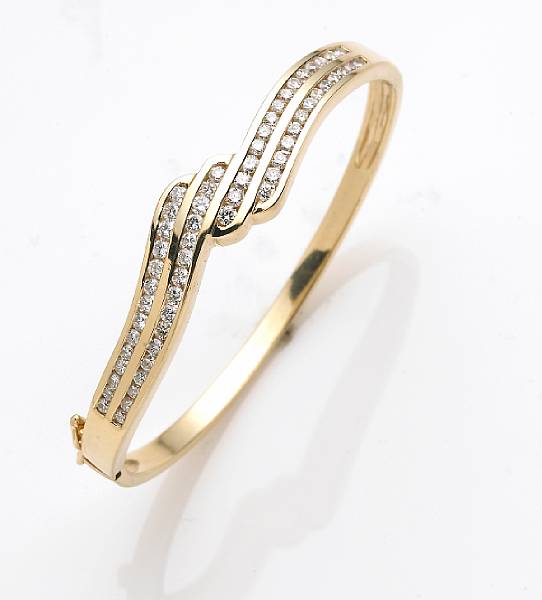 Appraisal: A diamond and k gold bangle bracelet estimated total diamond