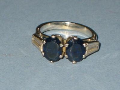 Appraisal: A SAPPHIRE AND DIAMOND DRESS RING with two oval sapphires